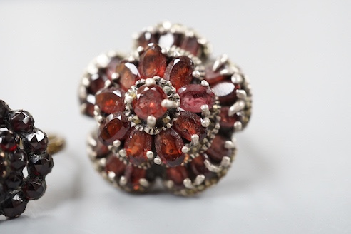 A Victorian garnet cluster set gilt metal dress ring, one other garnet set cluster ring and a garnet paste set hinged bangle.